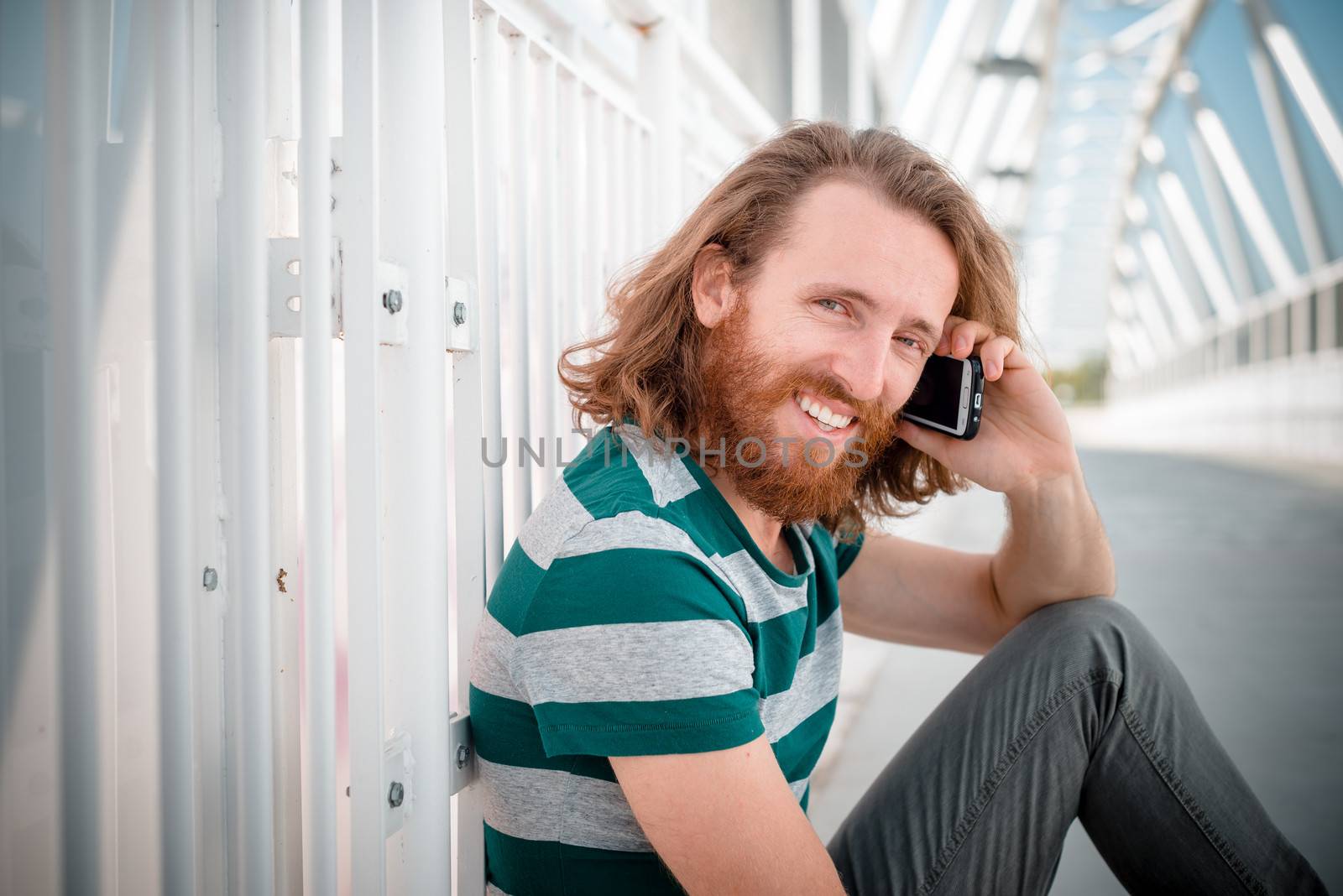 stylish hipster model with long red hair and beard lifestyle on  by peus