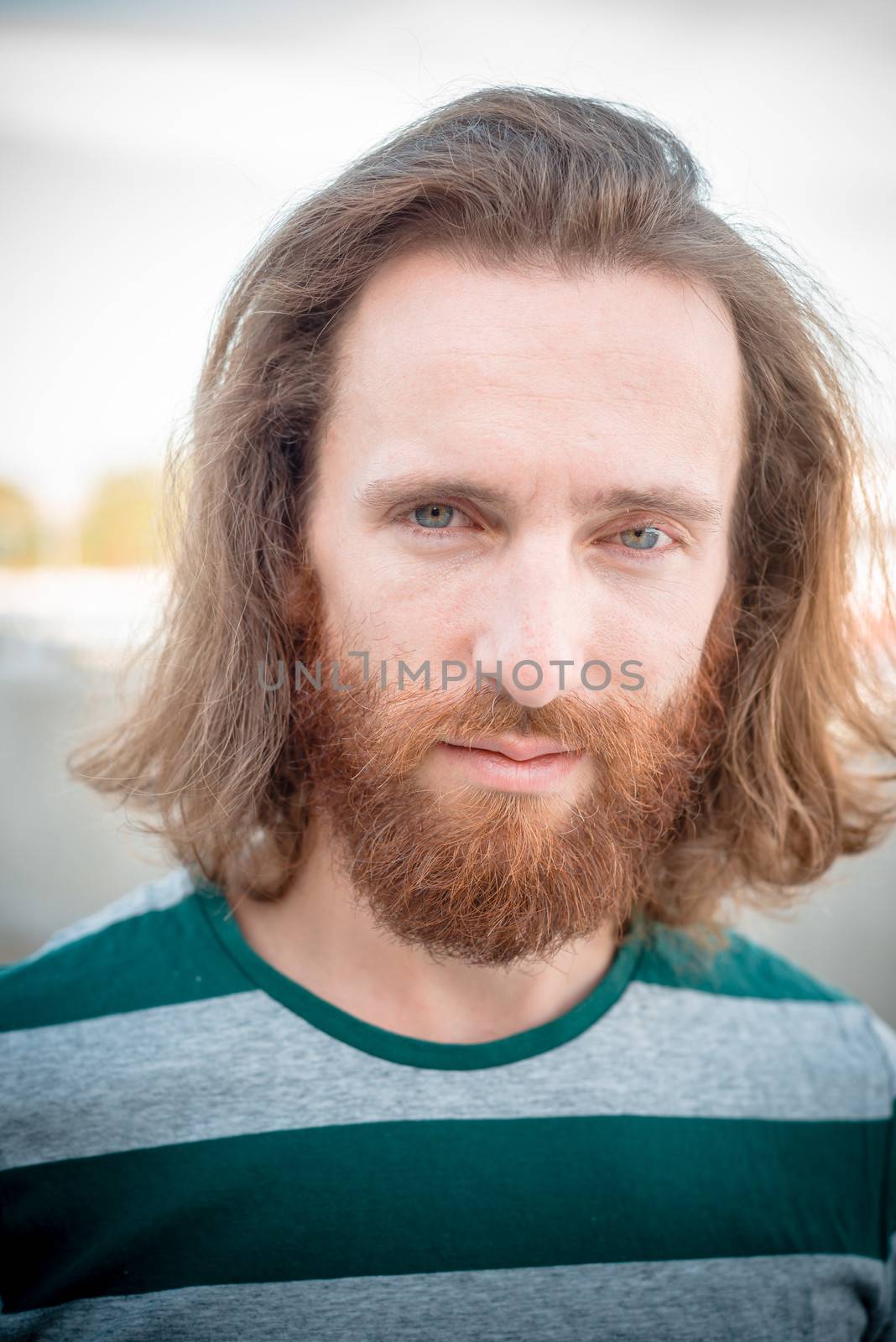 stylish hipster model with long red hair and beard lifestyle in the street