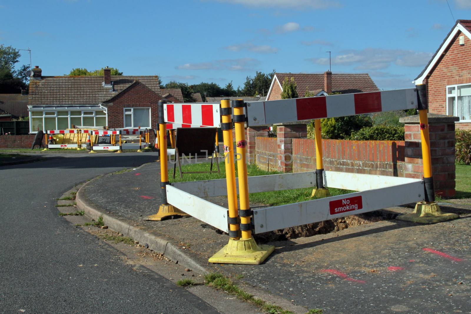 Road work warning signs and barriers in a street in England. 