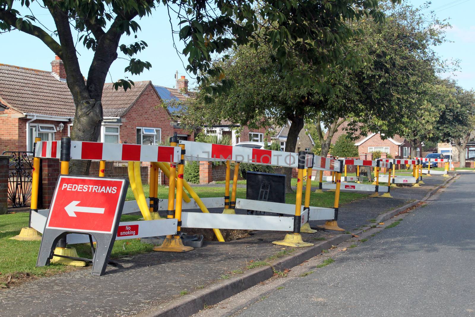 Road work warning signs and barriers in a street in England. 