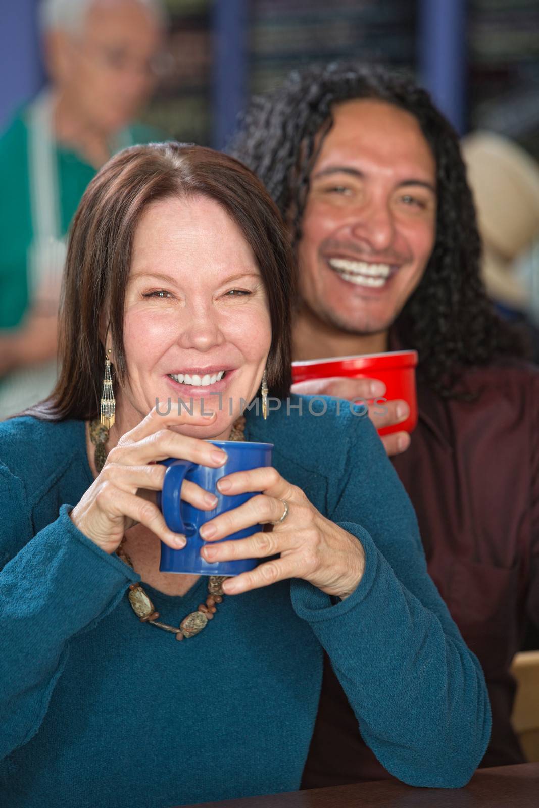 Smiling interracial couple sitting in coffee house