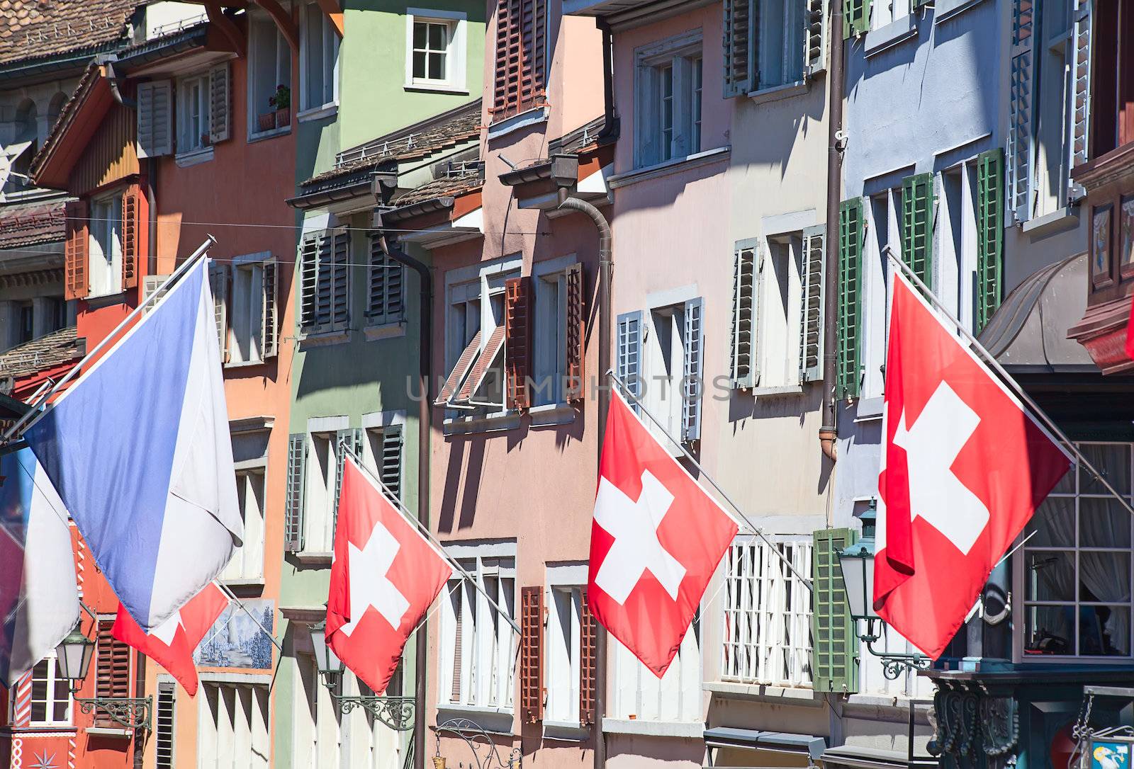 Ancient street Augustinergasse in Zurich decorated with swiss flags