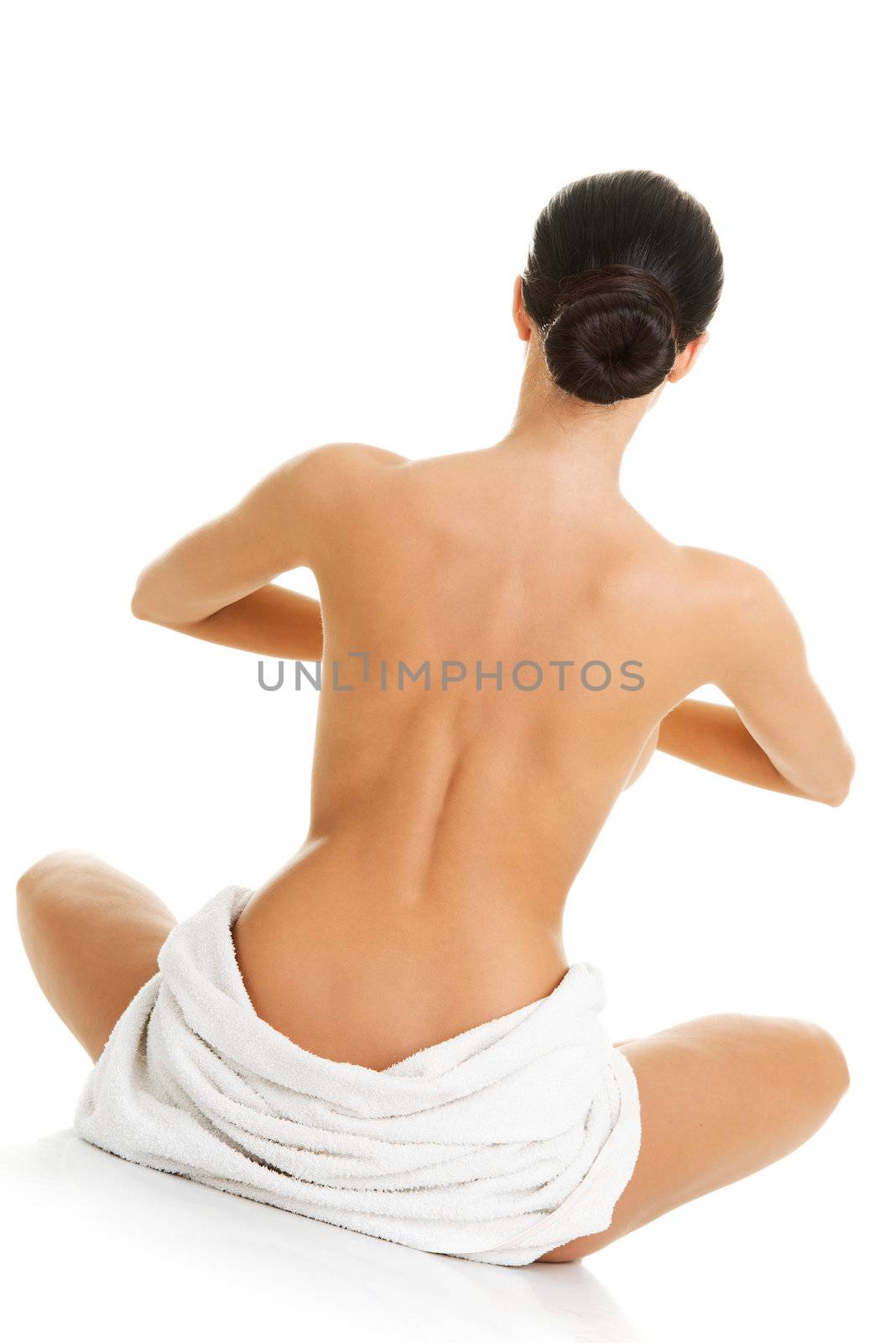 Young beautiful nude woman with towel practicing zoga , isolated on white