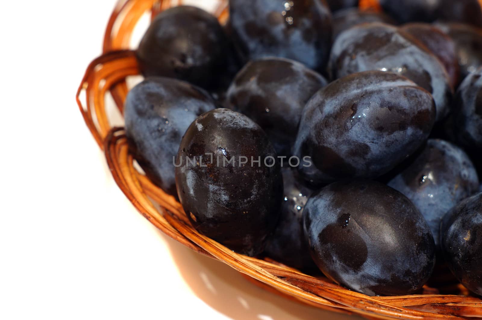 Plums in a basket close-up                          