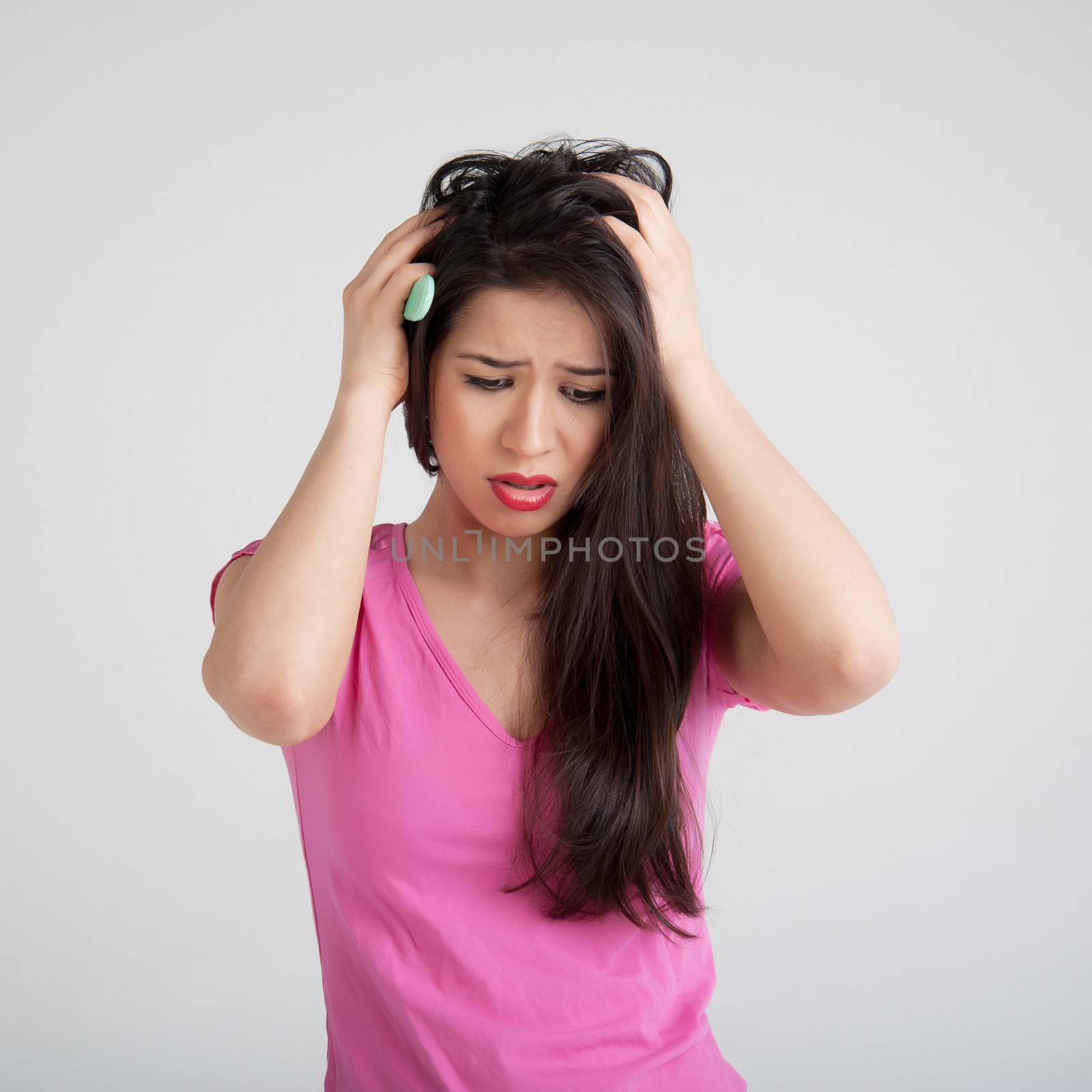 shocked woman losing hair on hairbrush