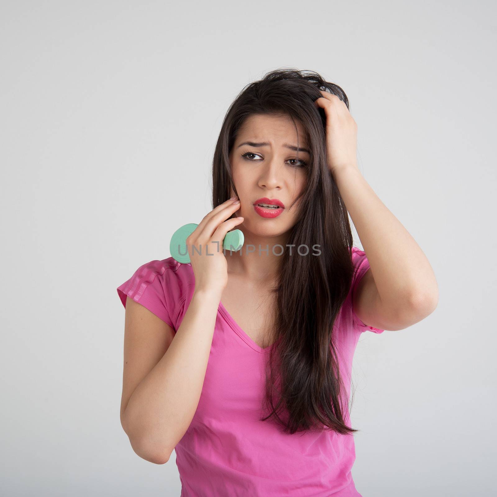 shocked woman losing hair on hairbrush