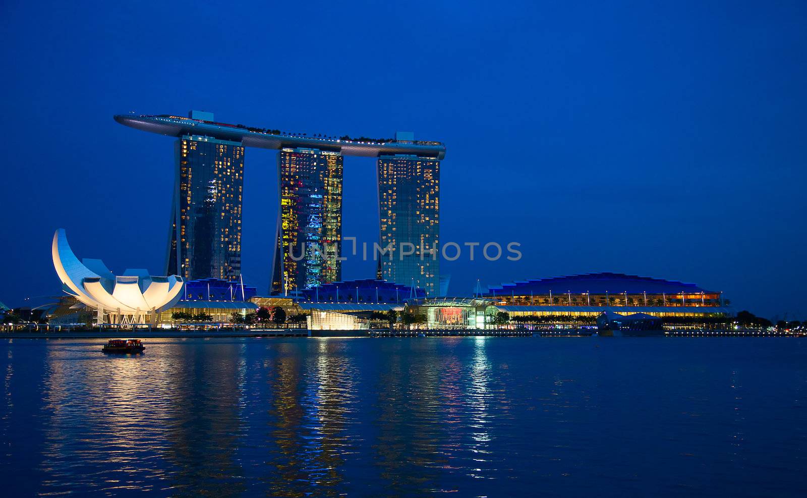 SINGAPORE - FEBRUARY 23: The Marina Bay Sands complex at night on February 23, 2013 in Singapore. Marina Bay Sands is an integrated resort and billed as the world's most expensive standalone casino property.