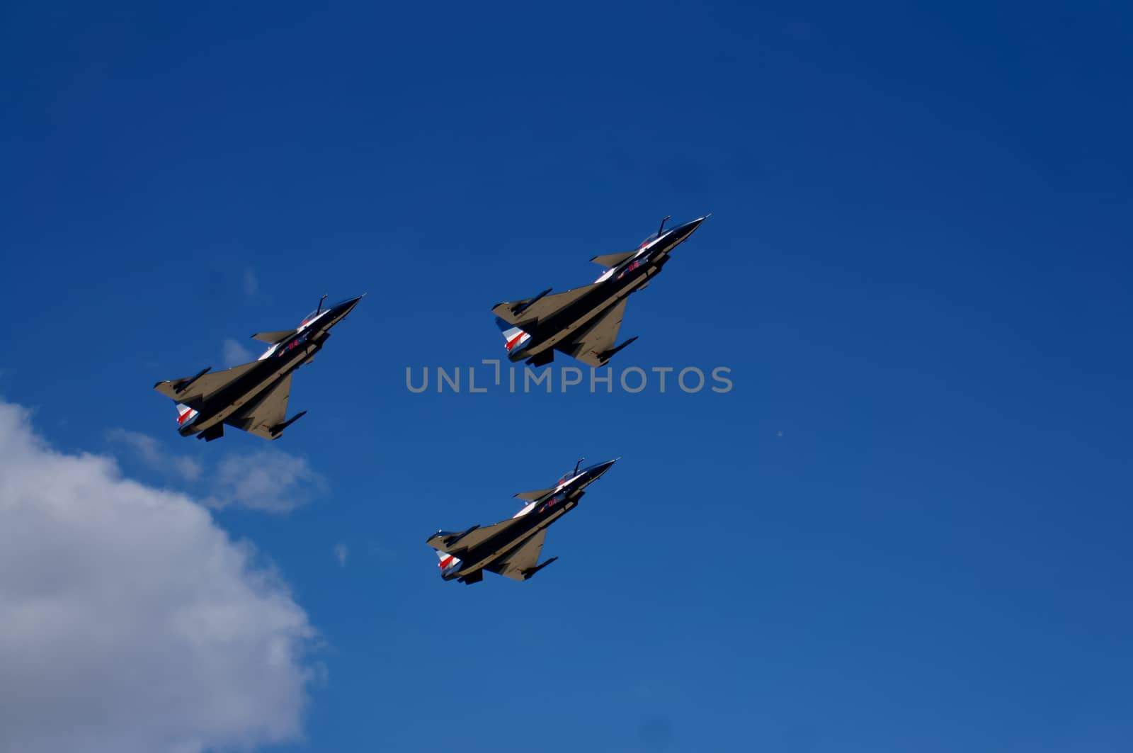 Three aircraft flying against the blue sky