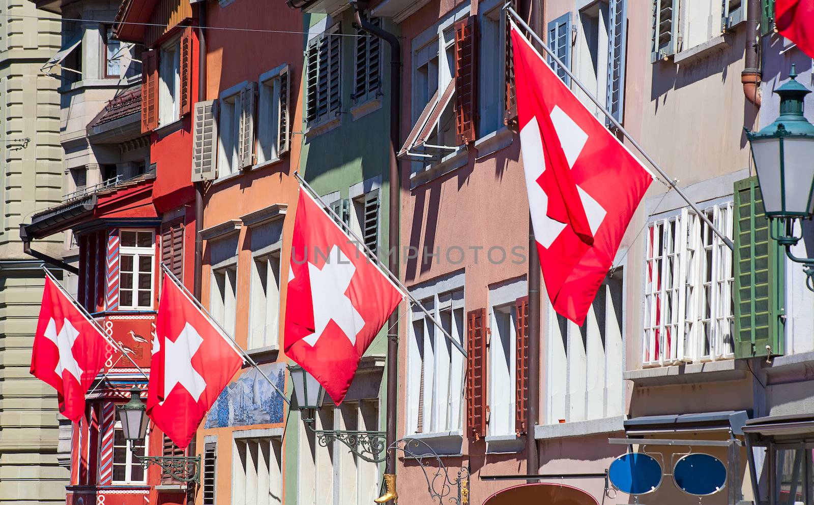 Ancient street Augustinergasse in Zurich decorated with swiss flags