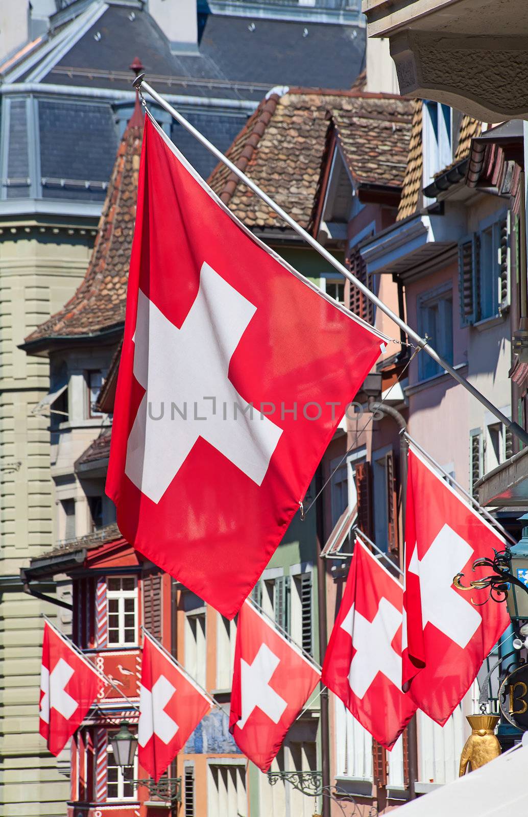 Ancient street Augustinergasse in Zurich decorated with swiss flags