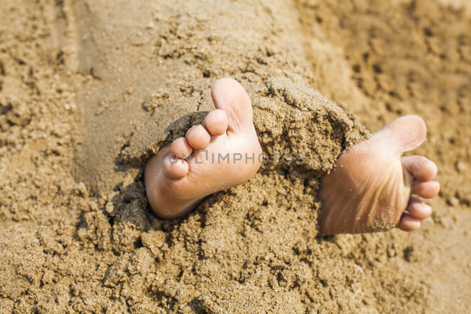 Child's feet in the sand by anelina