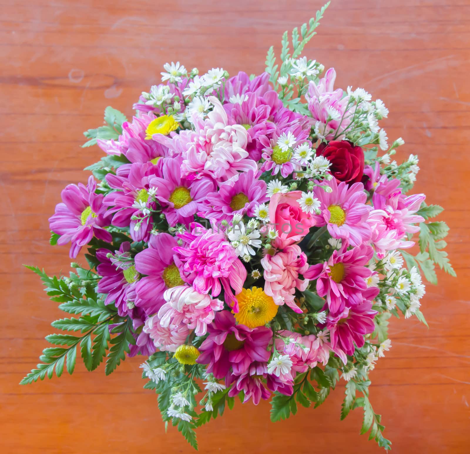 top view bouquet , mix  of fresh  flowers  on wooden table