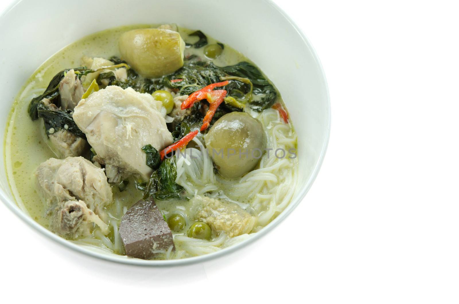 green chicken curry served with  rice vermicelli in white bowl over white background