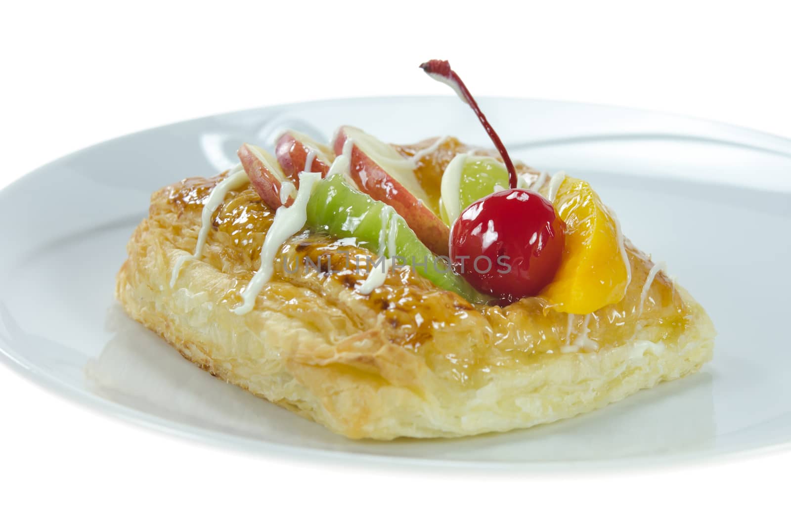 Apple Danish Topped With Glazed Fresh Fruit on plate over white background
