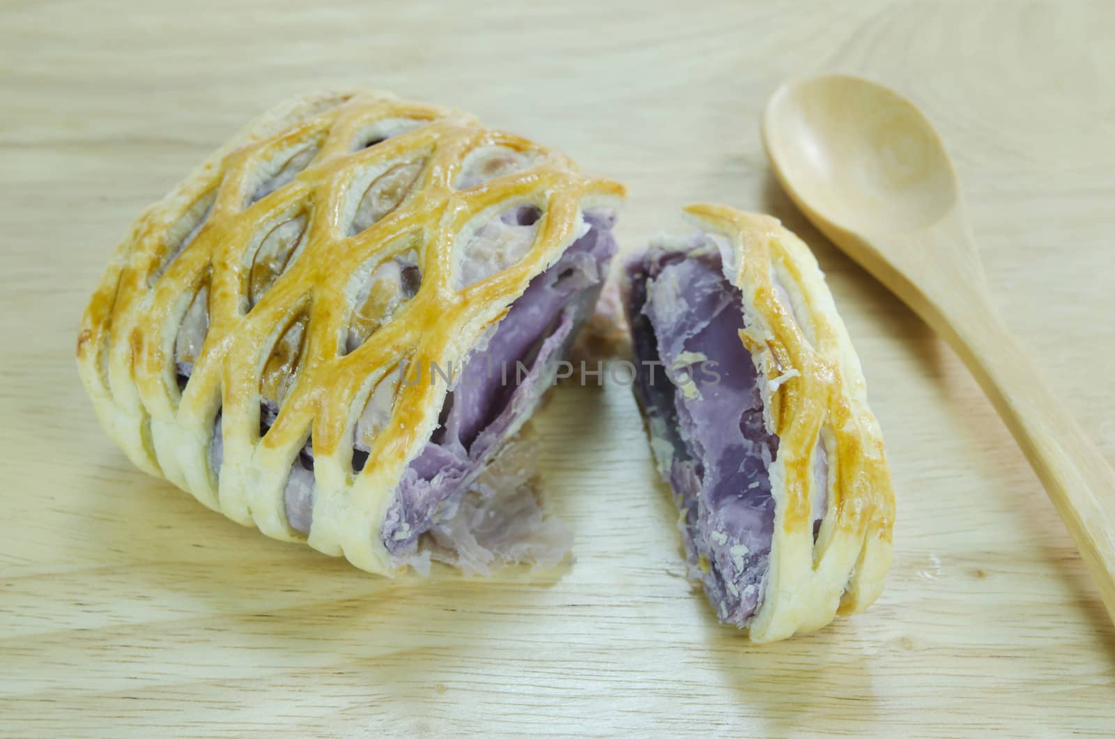 taro pies with wooden spoon on wooden background 
