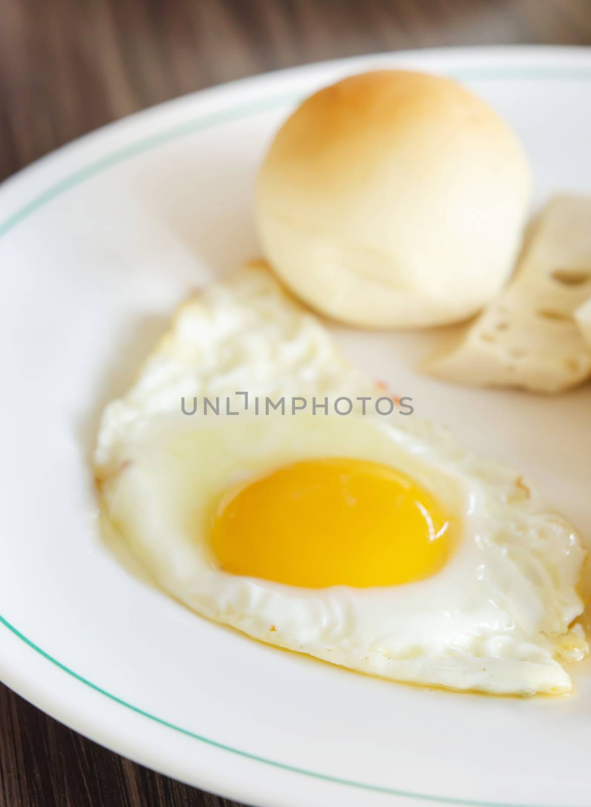 close up fried egg and bread on white dish