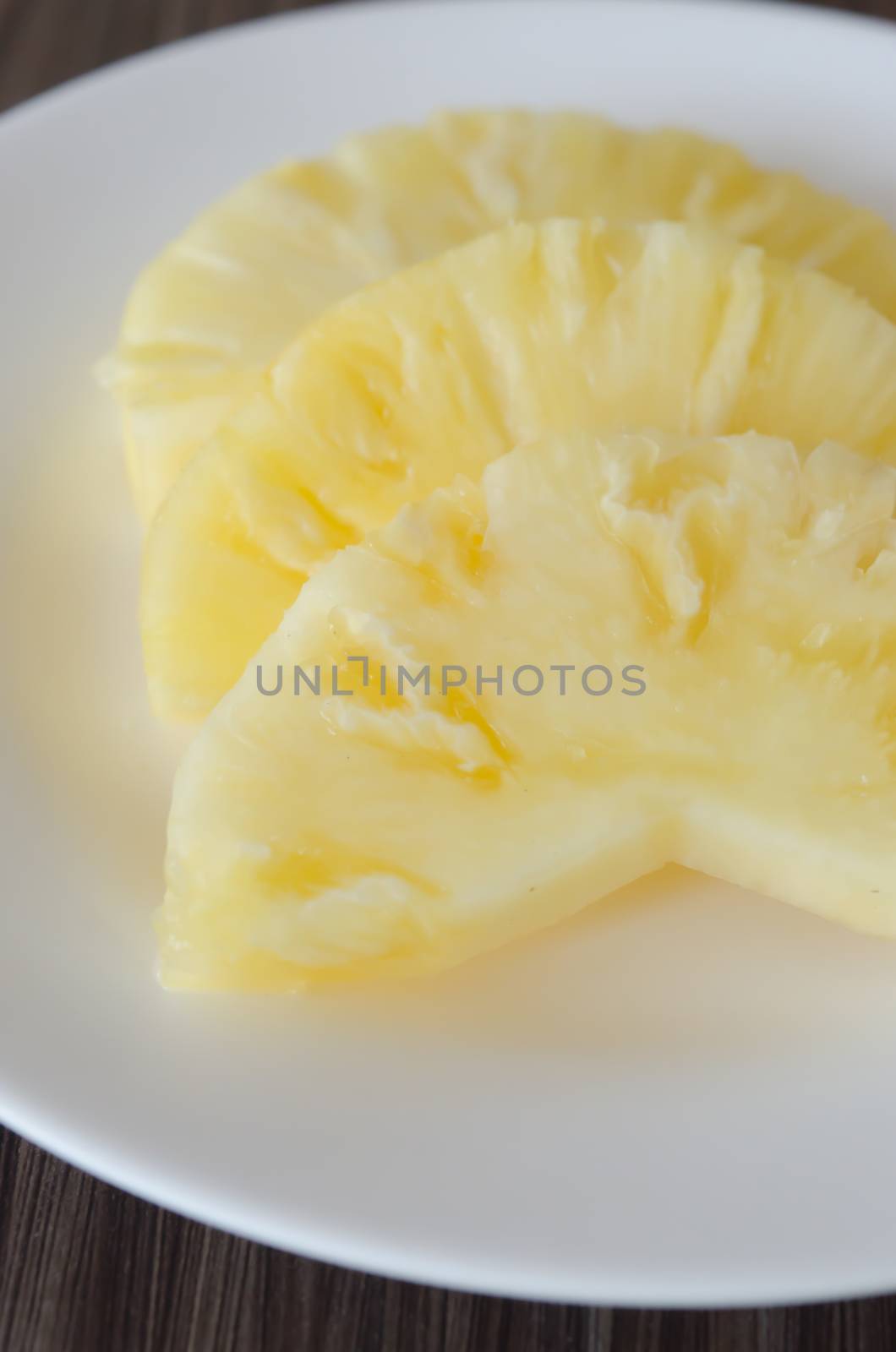 slices of  fresh pineapple  on white dish