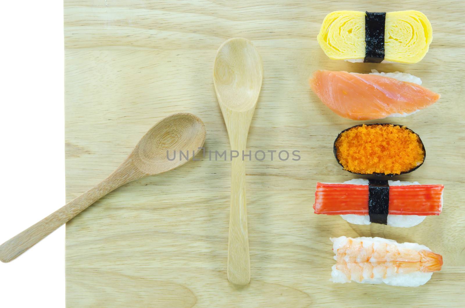 Japanese seafood sushi set , mix sushi rolls on wooden board with spoon