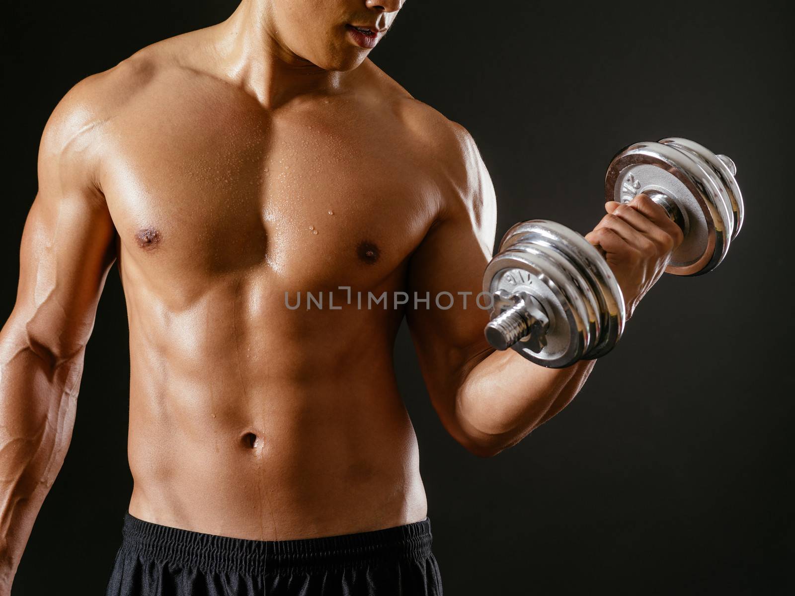 Asian male doing bicep curls by sumners