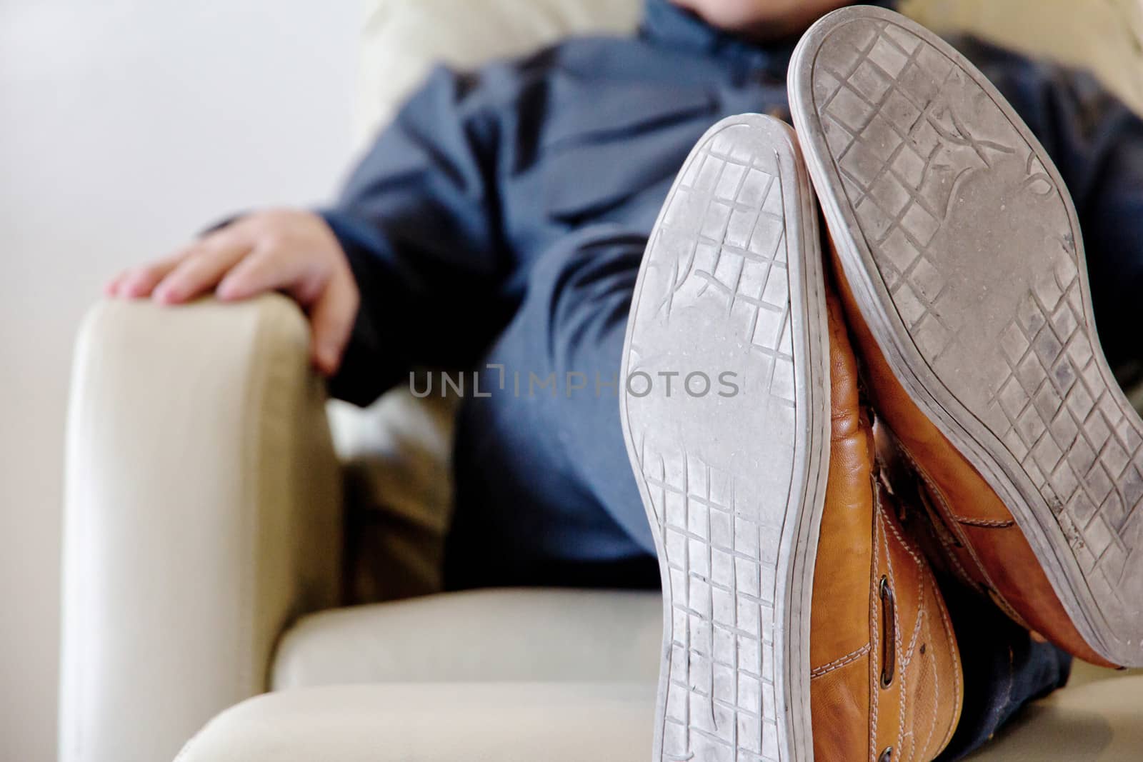 man lounging on armchair