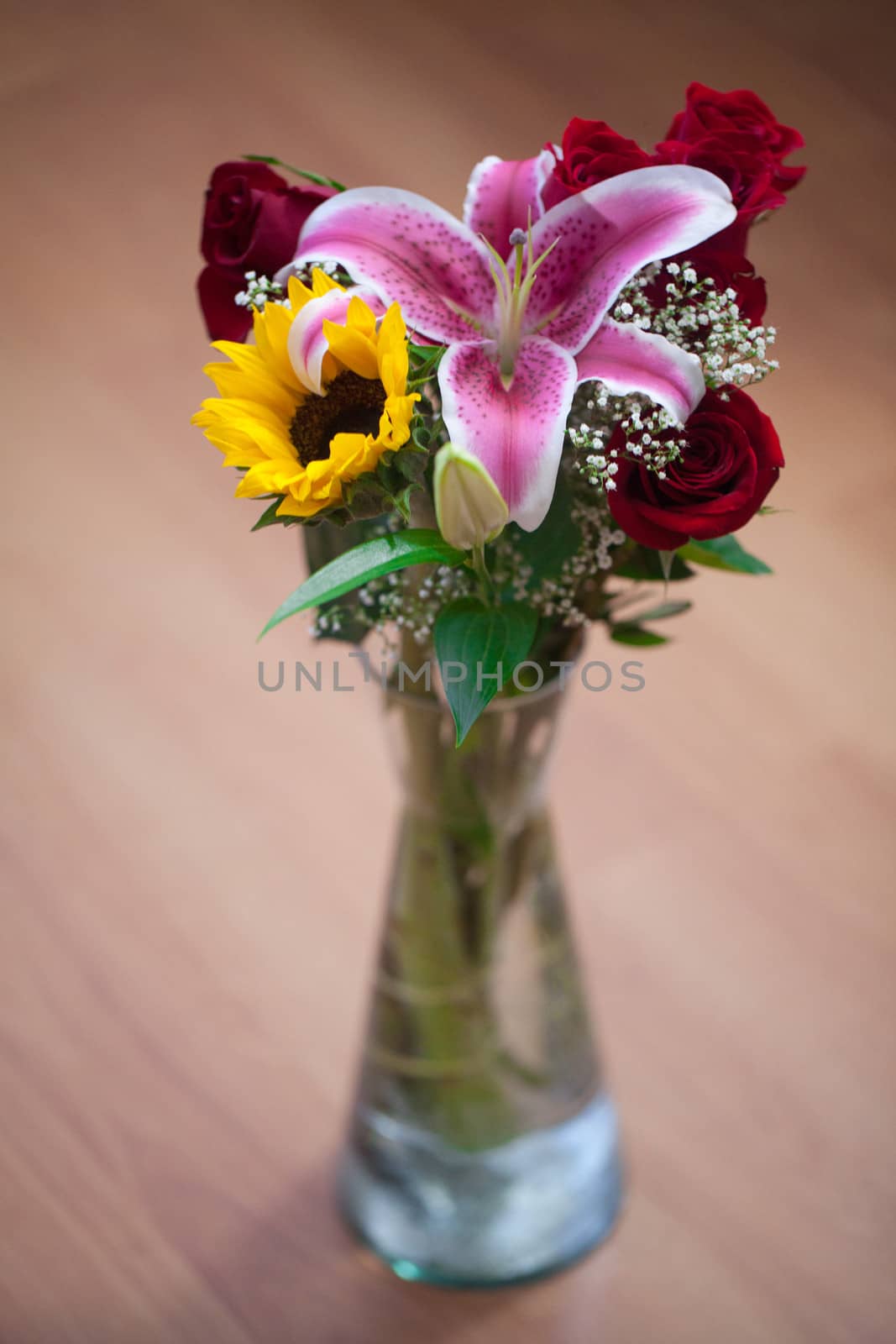 beautiful bouquet of sunflowers, lily and roses in a vase by jannyjus