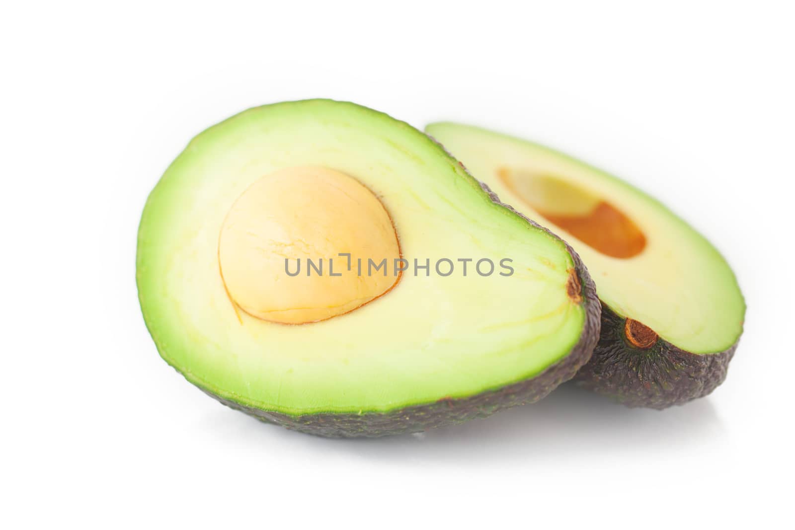 two halves of avocado isolated on white by jannyjus