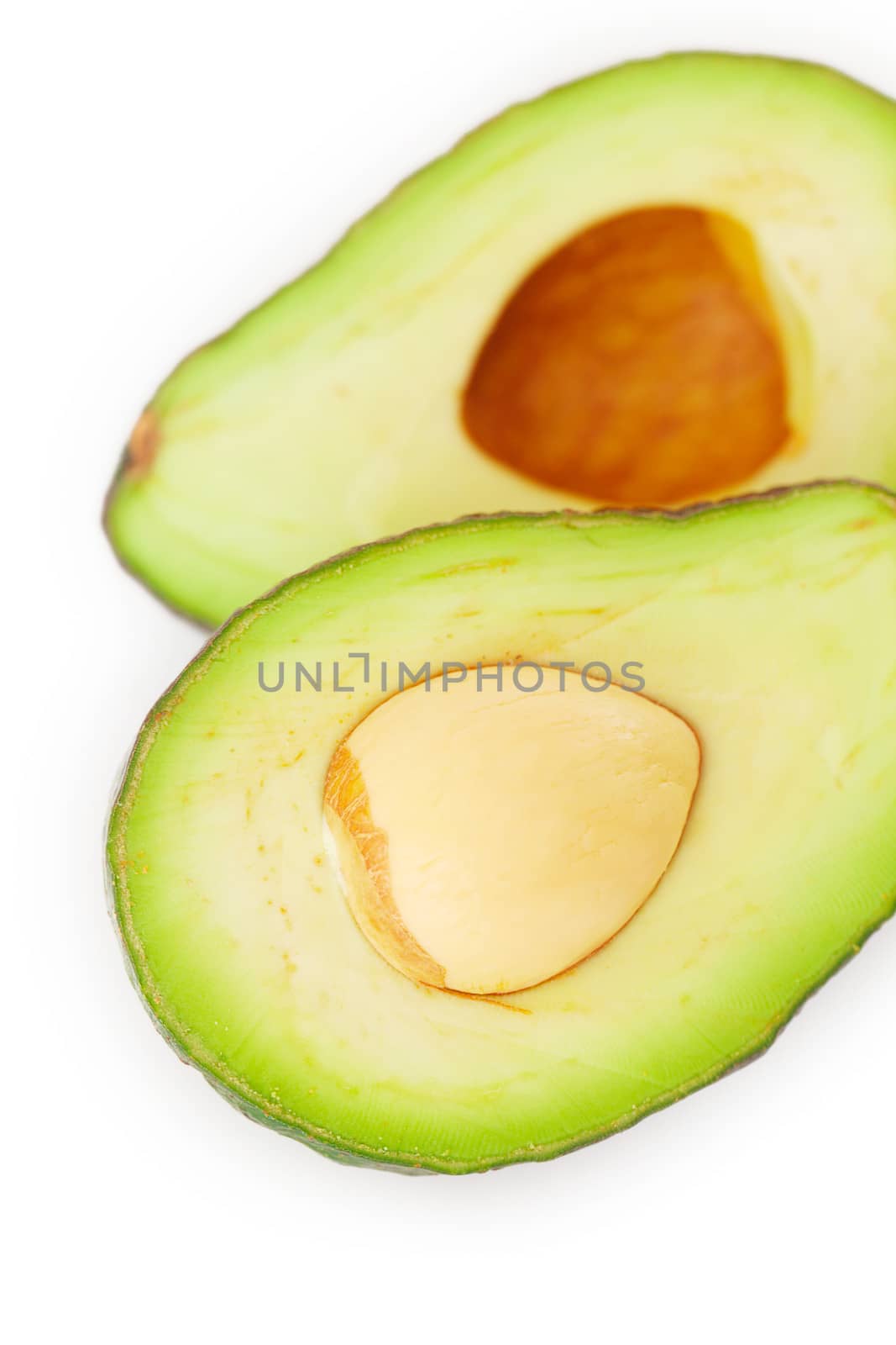 two halves of avocado isolated on white