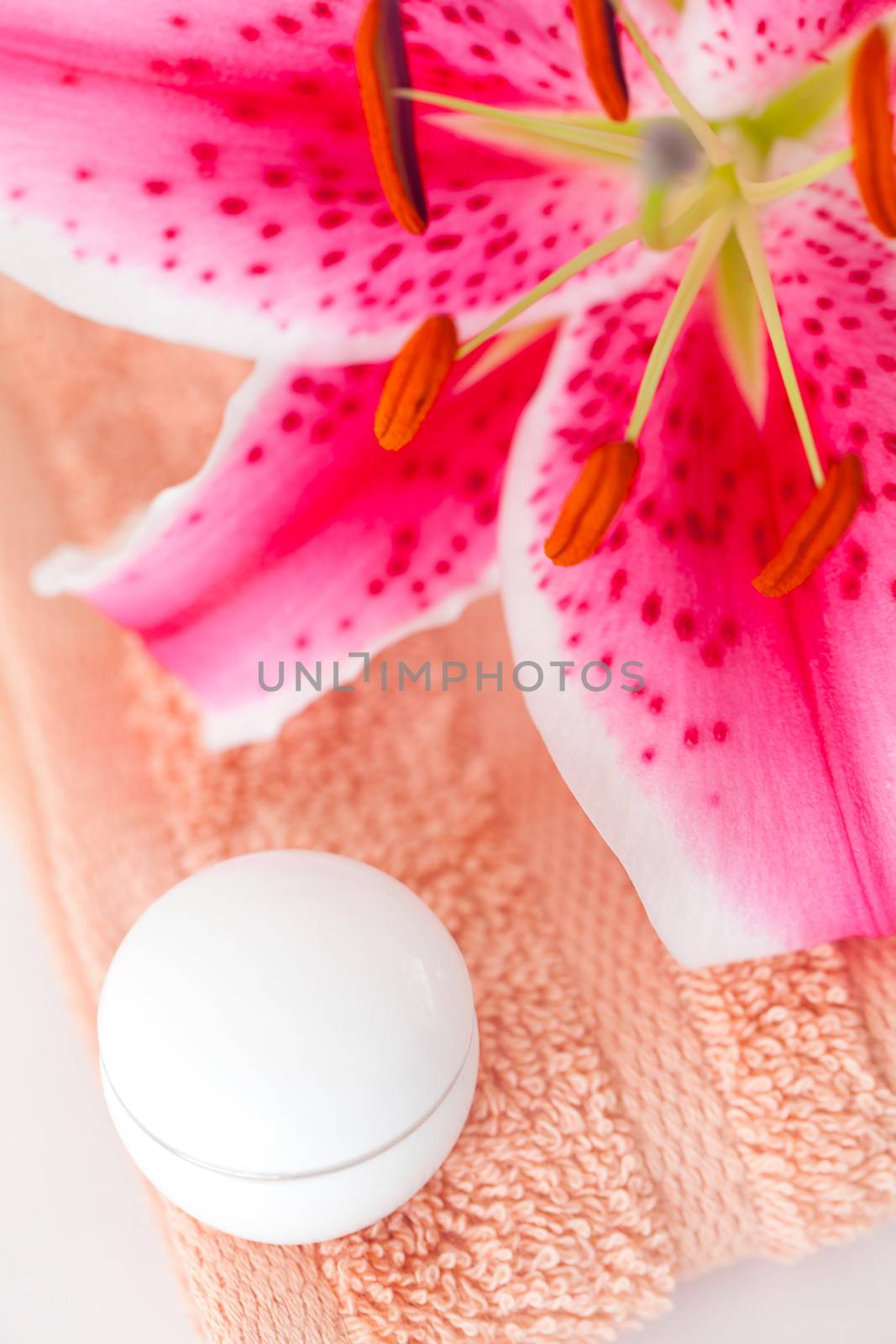 beautiful lily in a vase, towel and cosmetic containers by jannyjus
