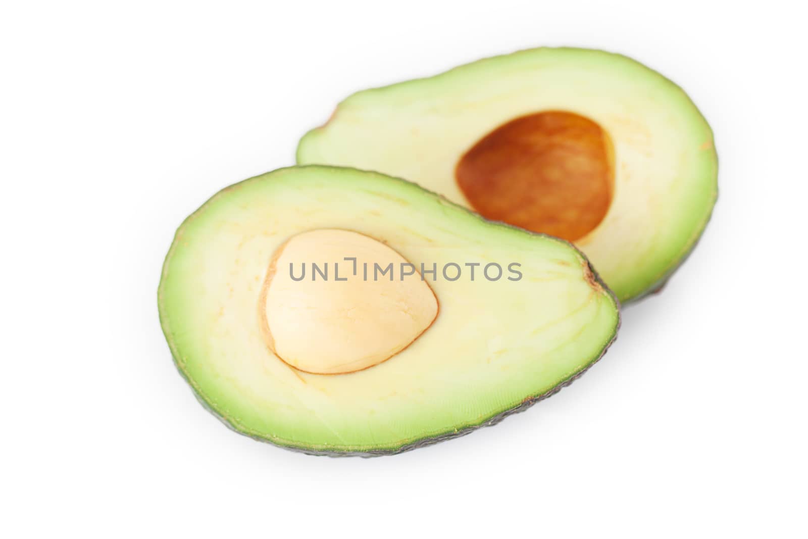 two halves of avocado isolated on white by jannyjus