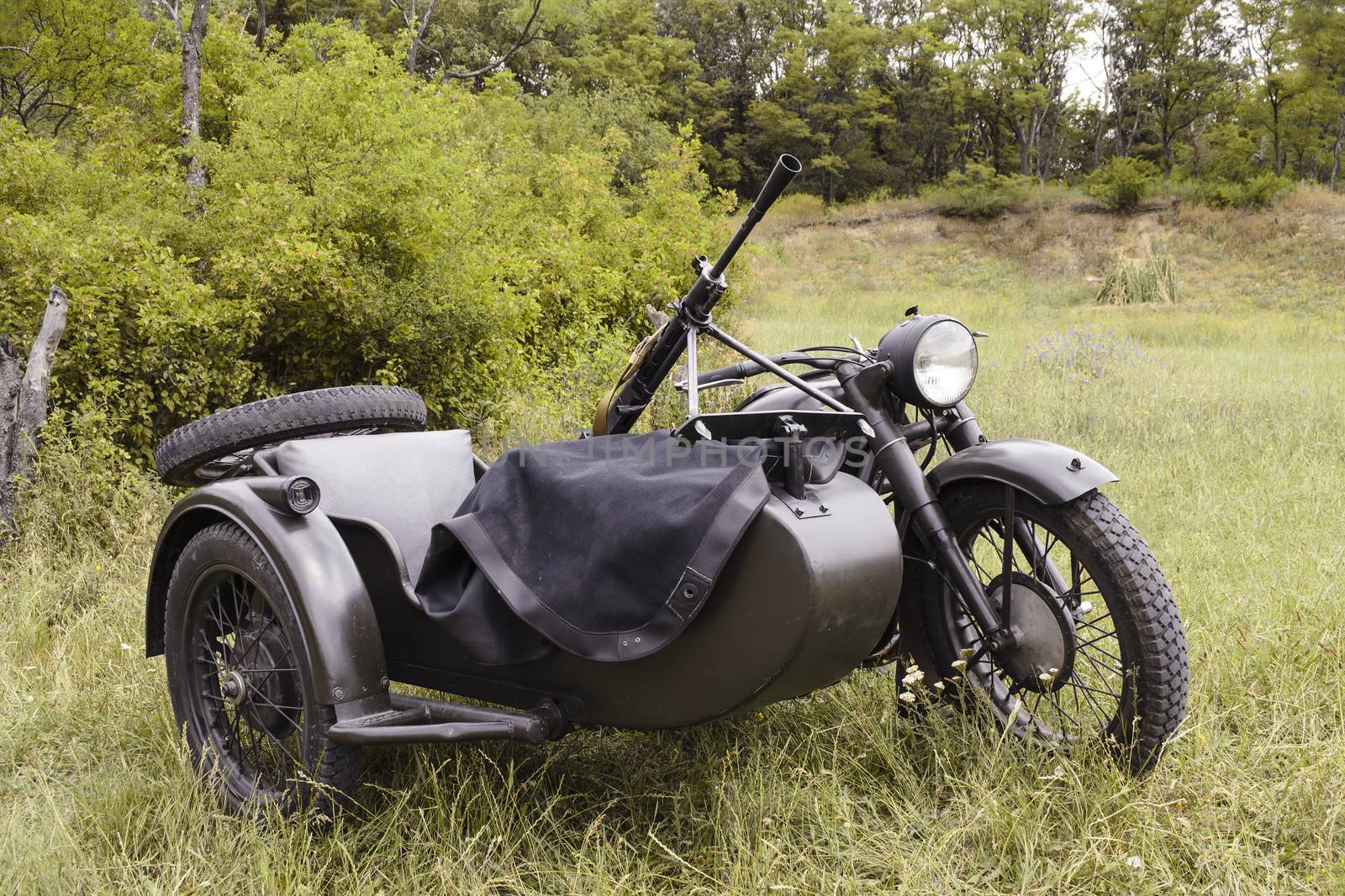 Old-fashioned Soviet motorcycle with sidecar since the Second World War, mounted with a machine gun.