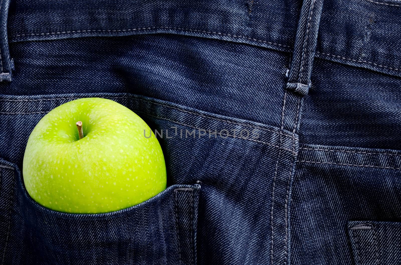 Green apple in Jeans pocket