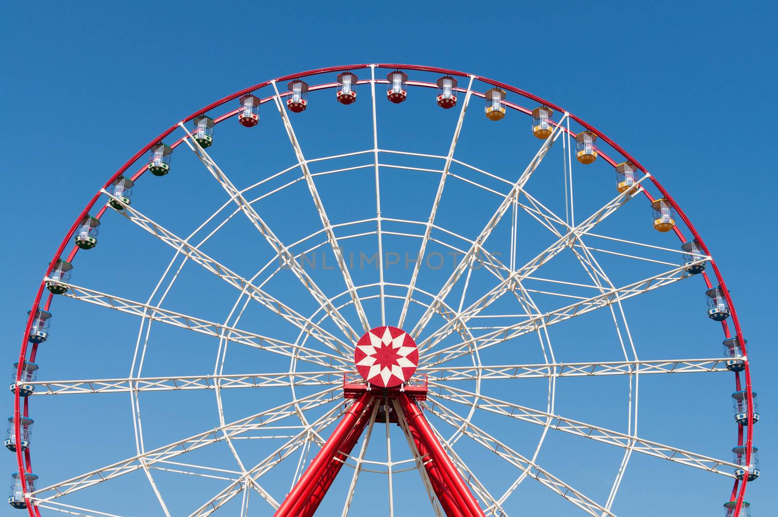 Big ferris wheel on blue sky background.