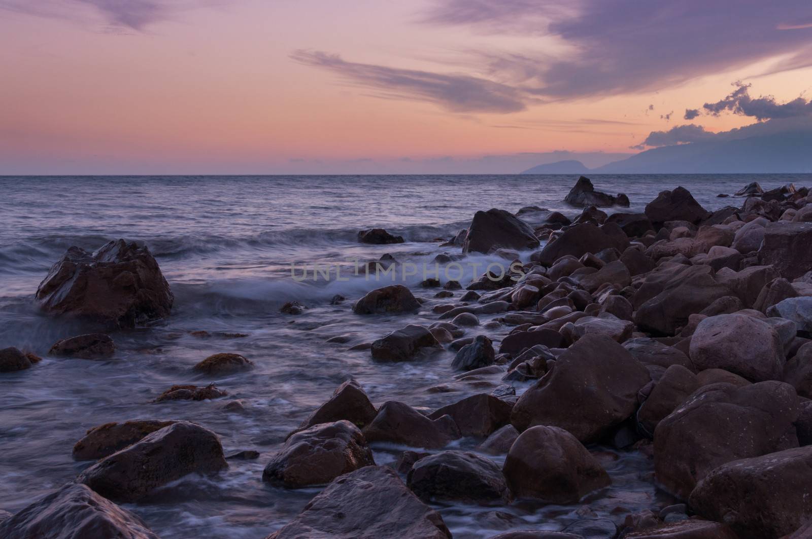Rocky shore during a beautiful sunset over the sea. by BPhoto