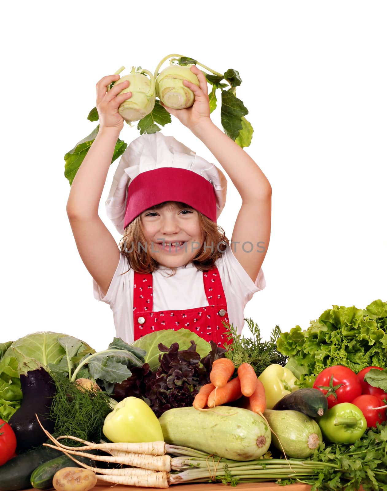 little girl cook with different vegetables by goce