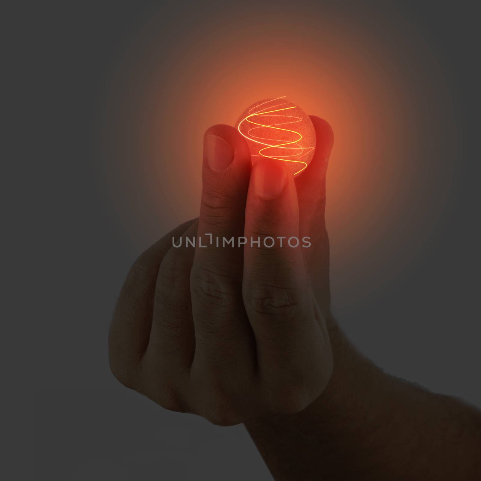 Glowing sphere held in a male hand
