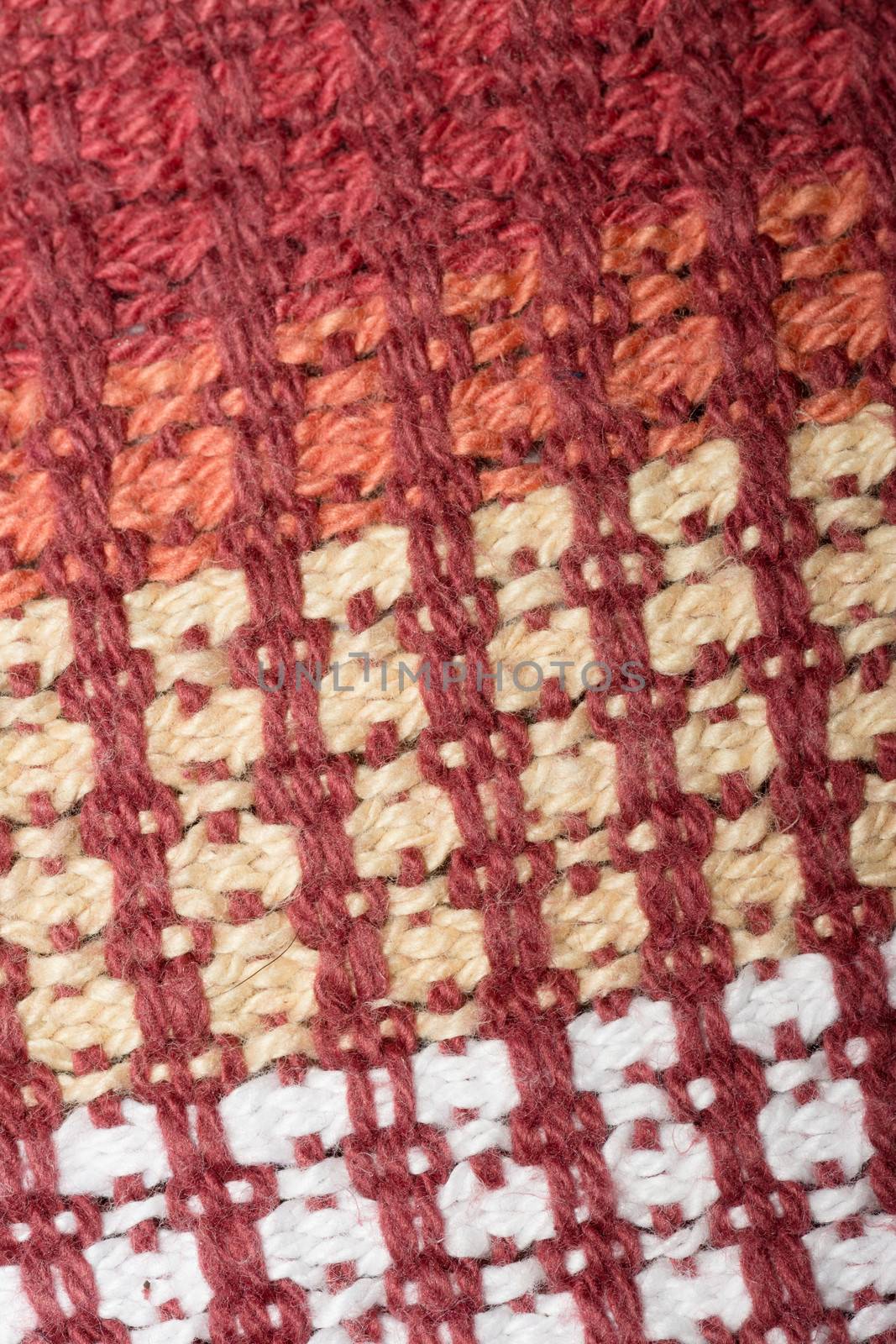 Red, beige and white knitted wool close-up
