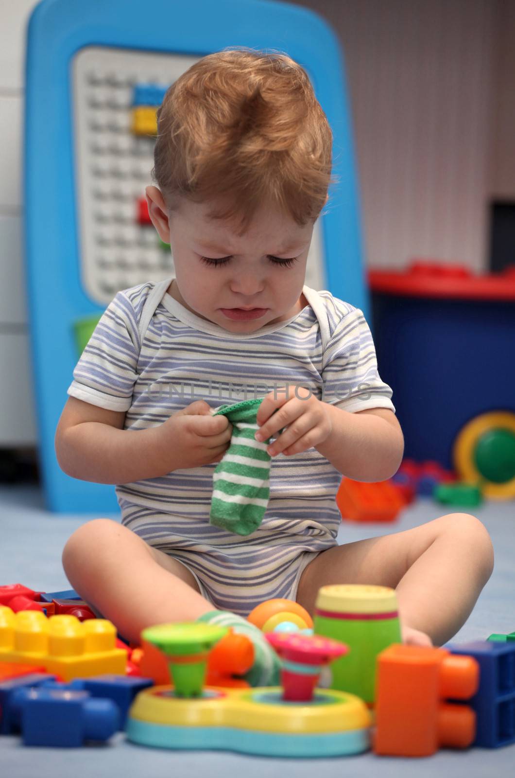 A baby boy crying in children's room