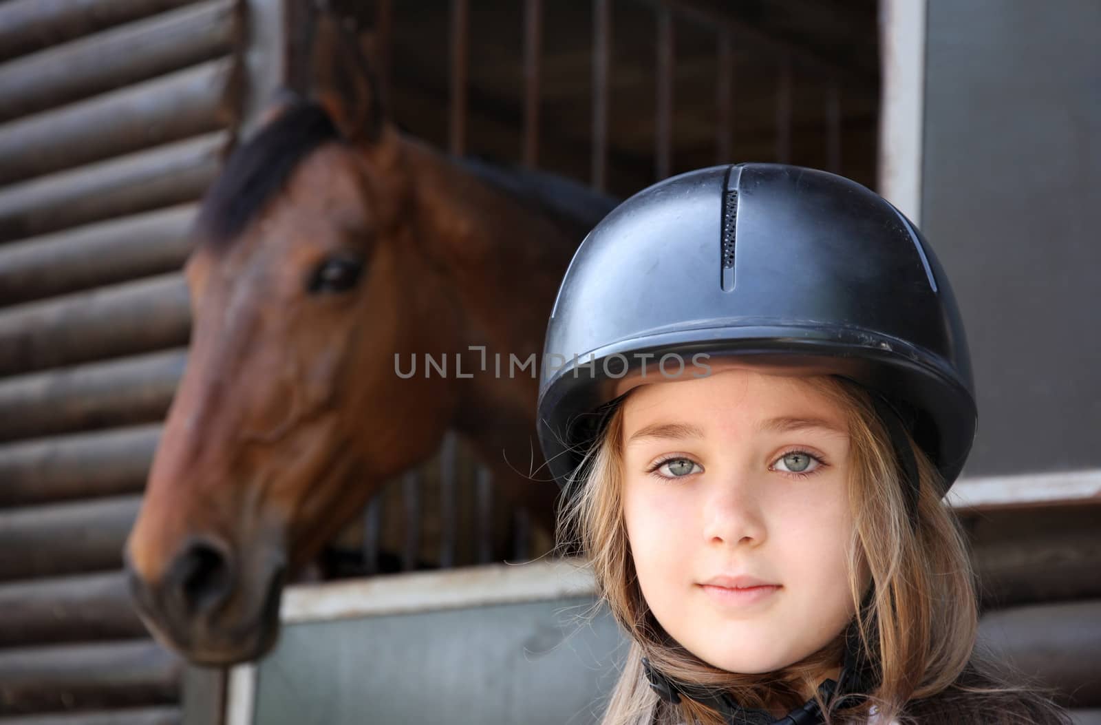 Portrait of little girl and brown Horse