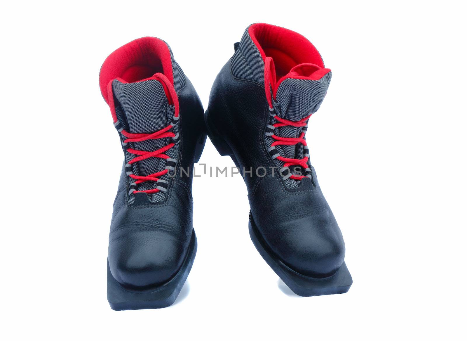 Leather black ski boots with a red lining. Are presented on a white background.