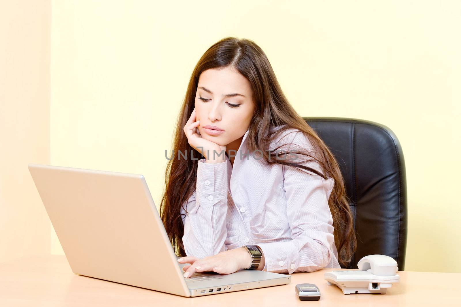 Brunette business woman working on computer in office