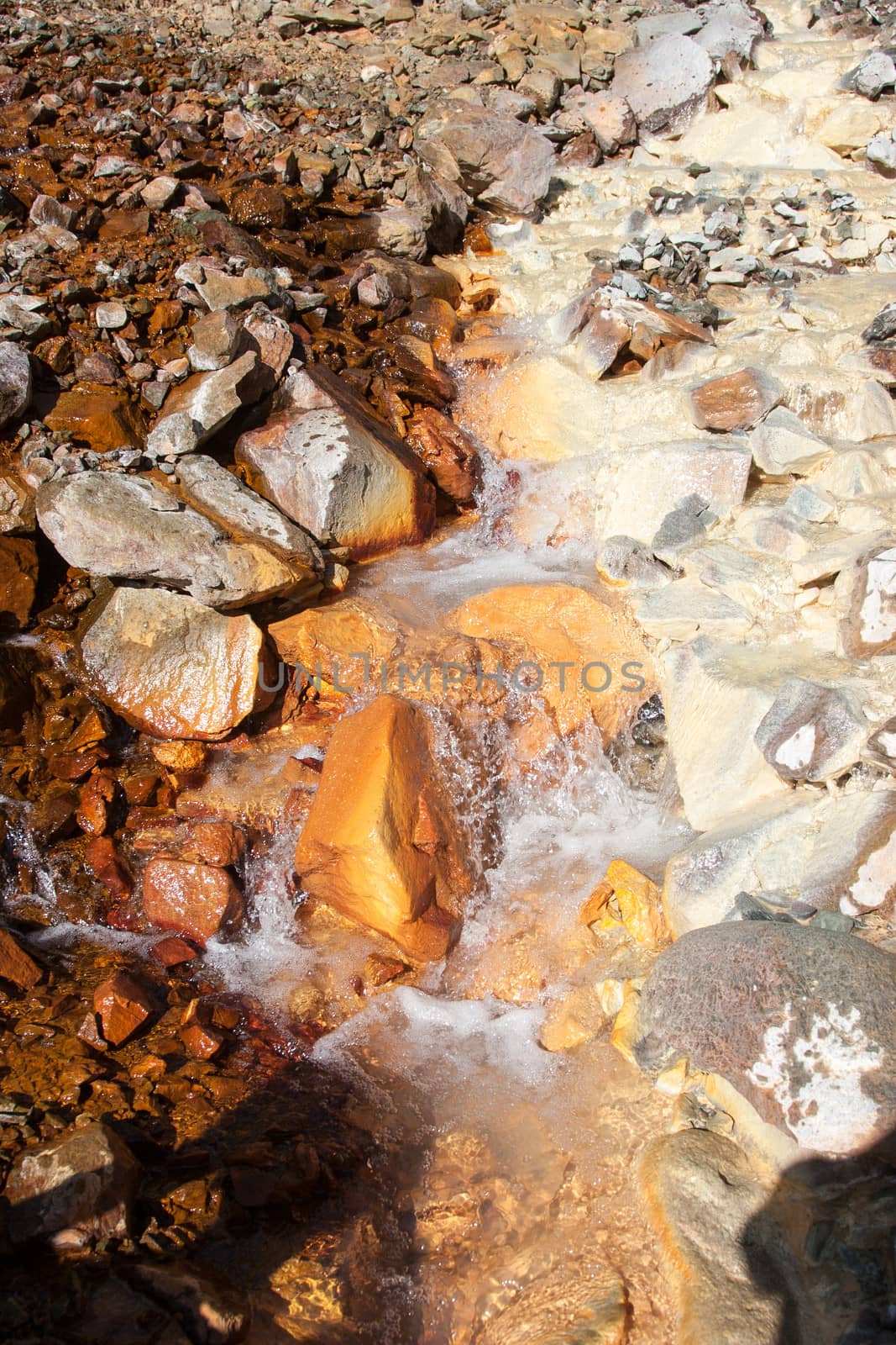 Two streams loaded with mineral content merge into one.