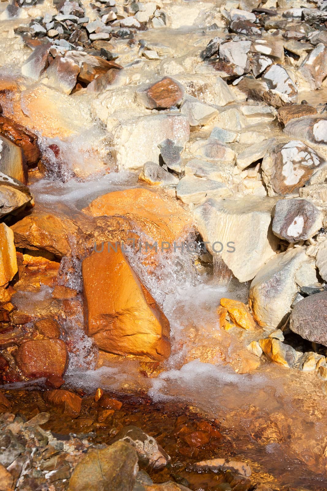 Two streams loaded with mineral content merge into one.
