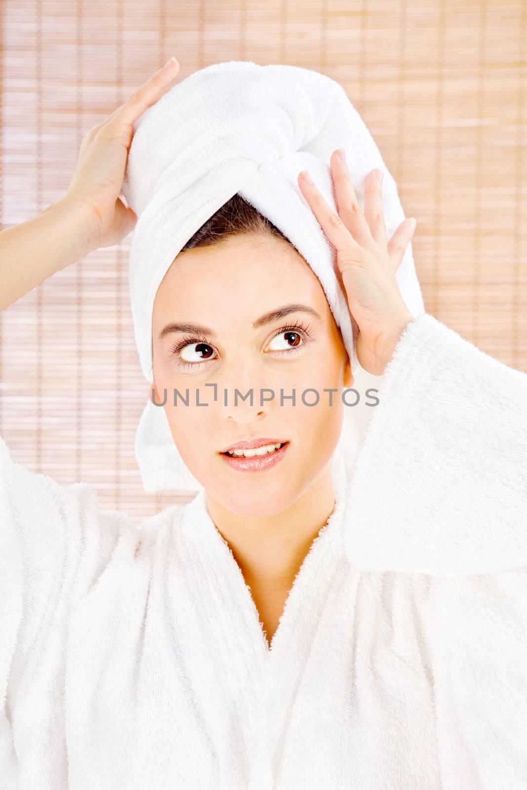 brunette woman with towel in spa center