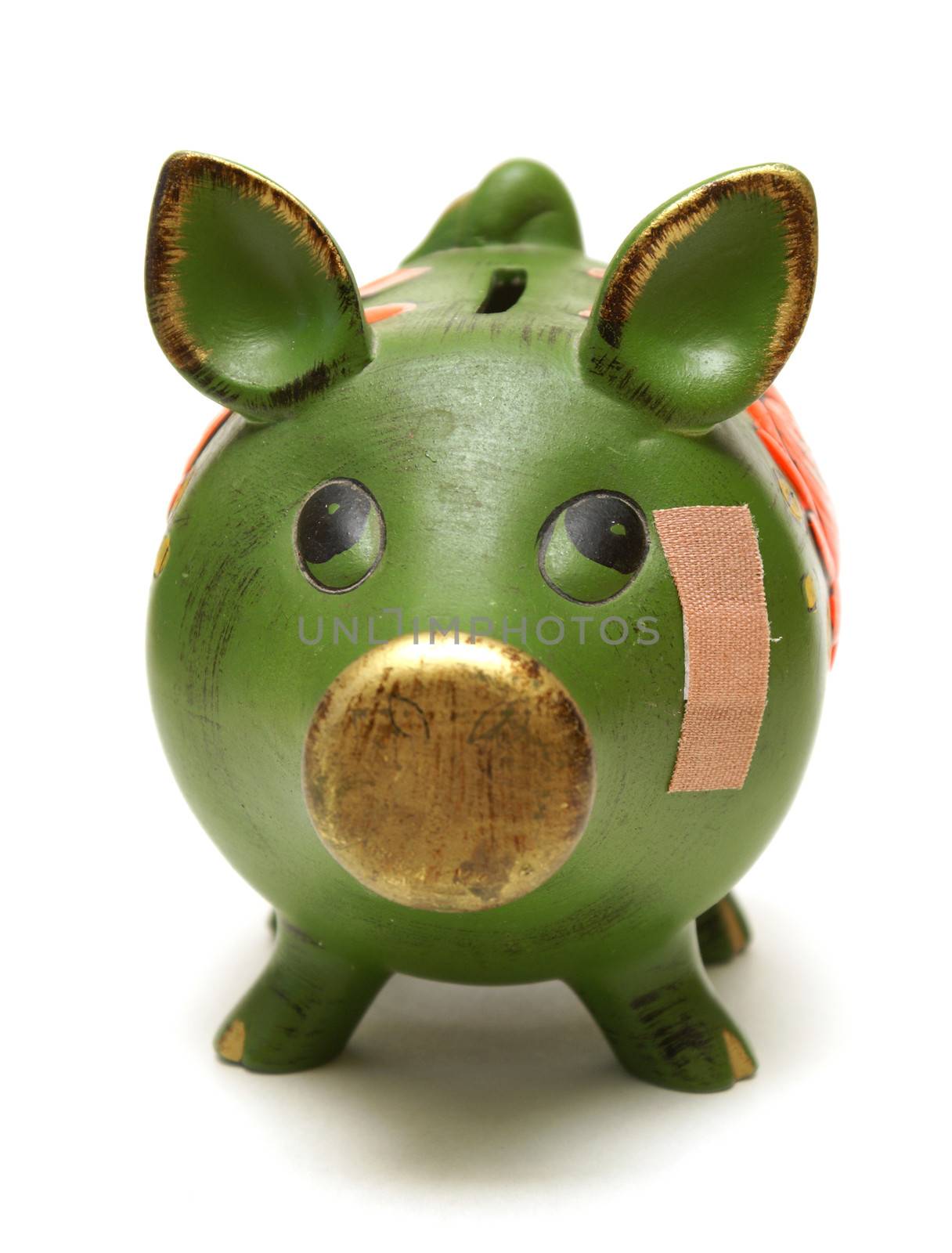 A pig bank and bandage represent financial concepts.