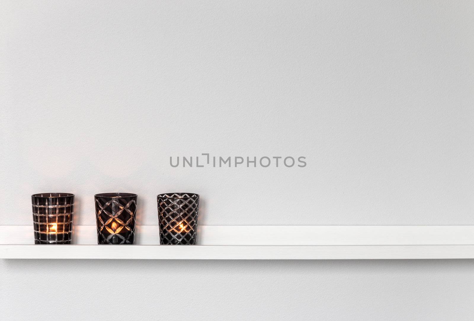 Home decor, candle lights on a white shelf.