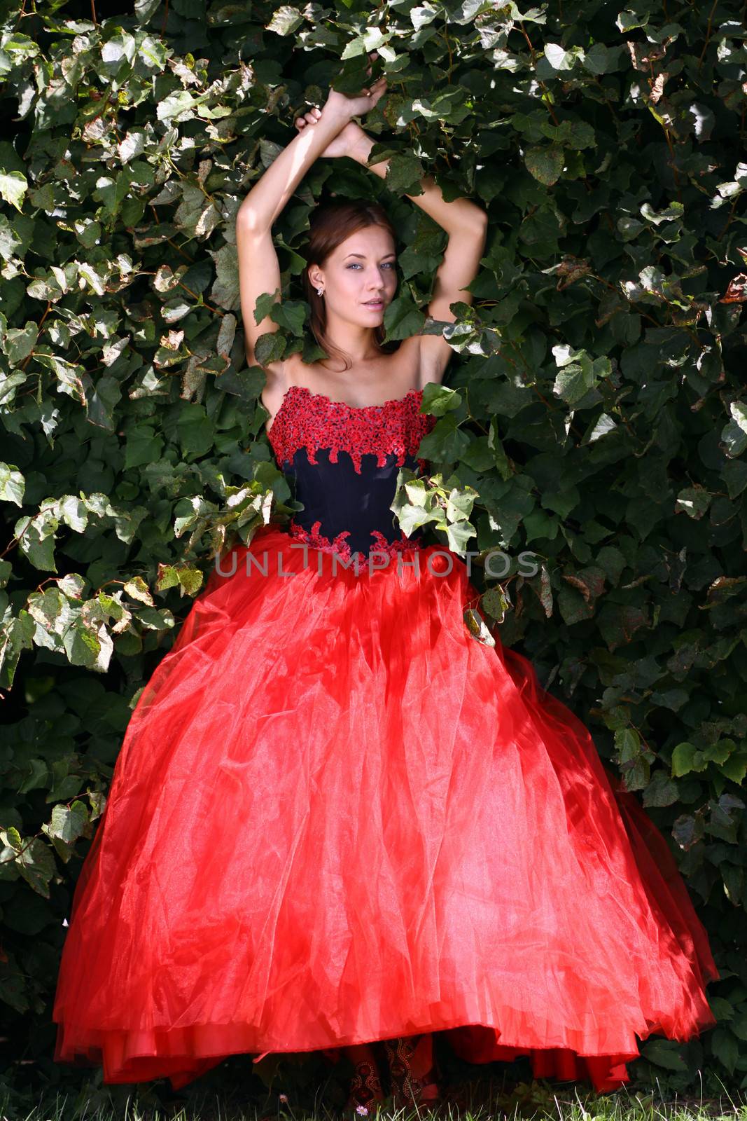 Young woman in a red gothic dress