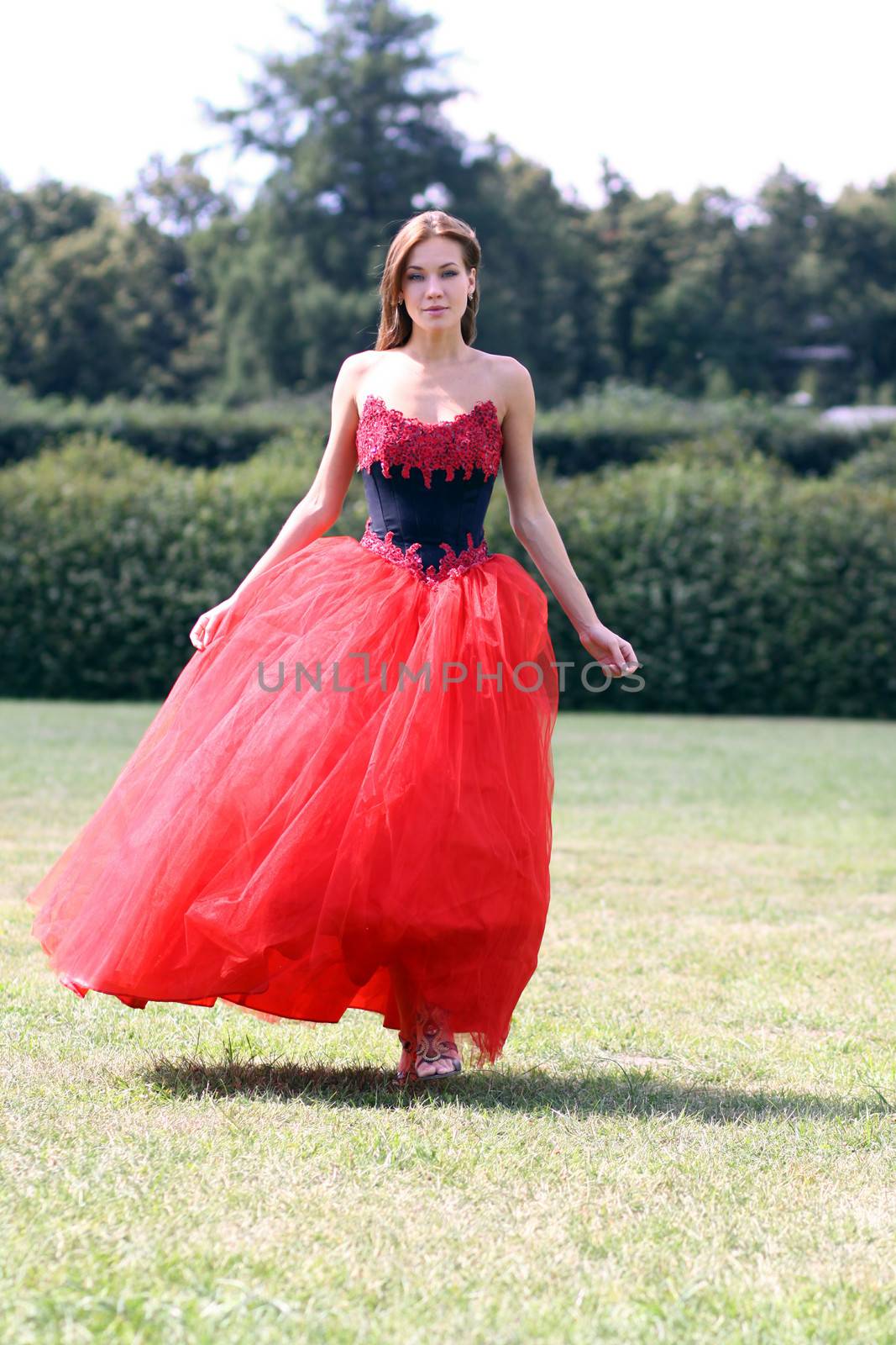 Young woman in a red gothic dress