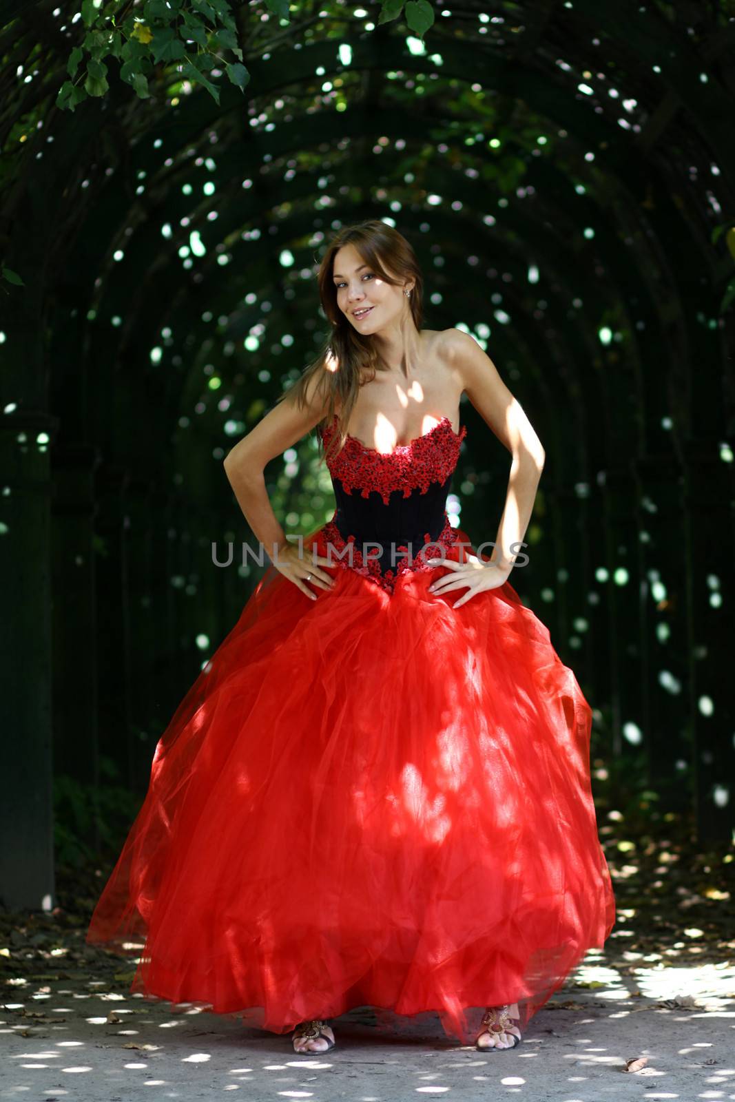 Young woman in a red gothic dress
