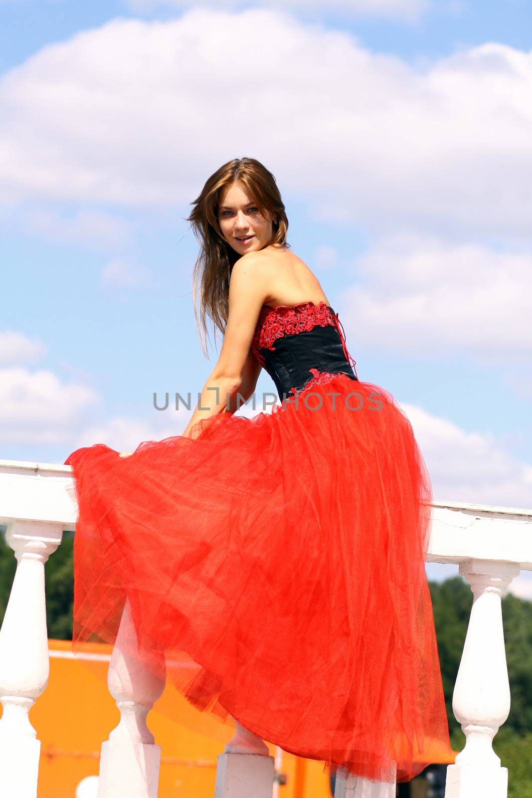 Young woman in a red gothic dress