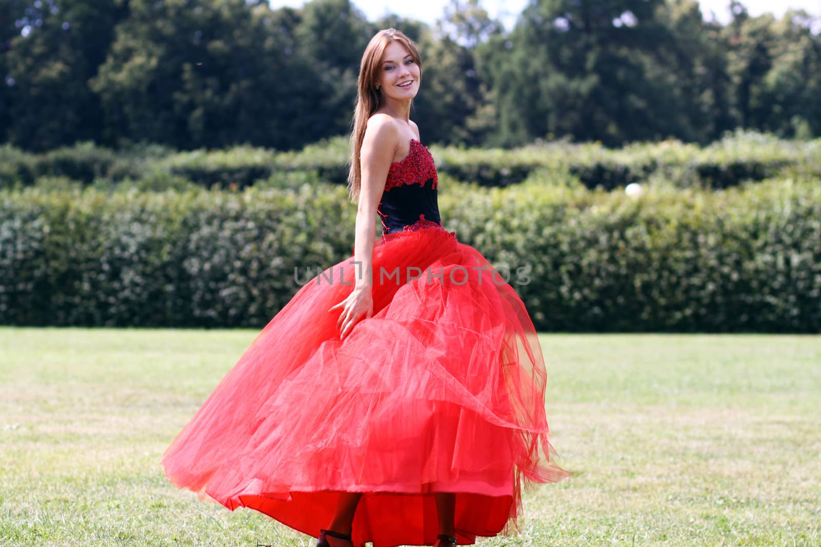 Young woman in a red gothic dress